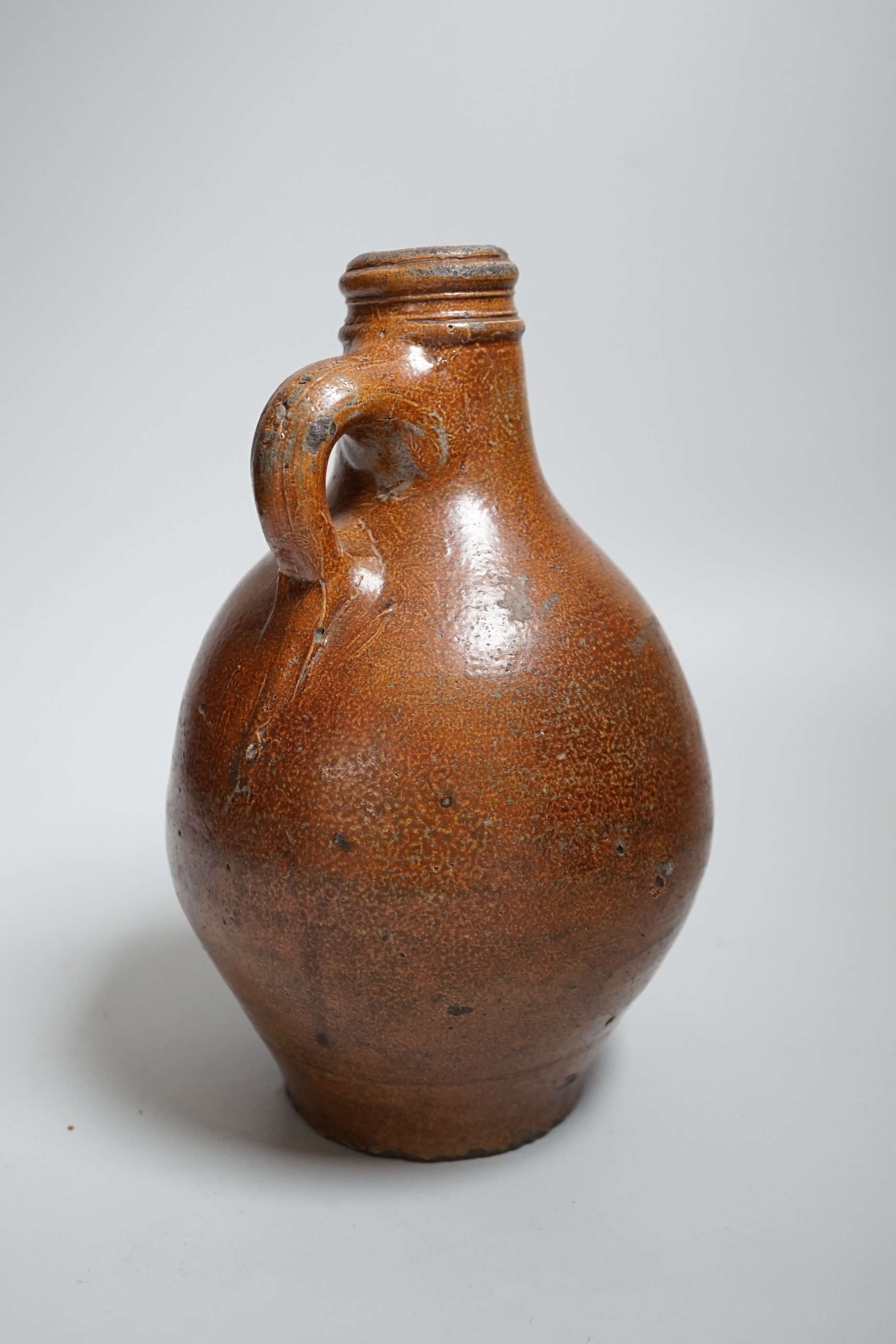 A 17th century stoneware Bellarmine or Bartmann jug, 23.5cm